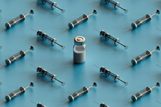 syringes around a vaccine vial