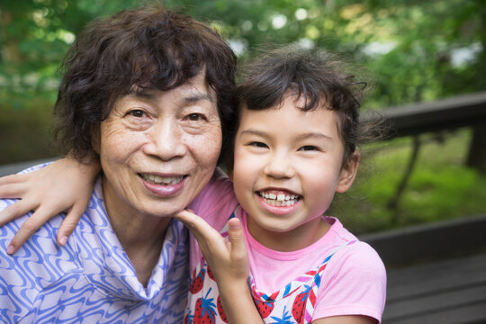 Happy Aisan grandmother and grandchild: tho generations