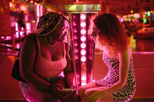 Two young people talking at a fair