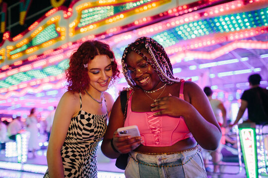 Smiley young woman using a mobile phone