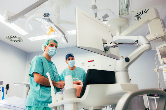 Colleagues making an ultrasound patient's thyroid gland in clinic