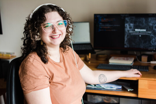 Happy woman working as a web developer portrait