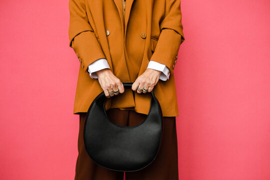 Details of stylish outfit on pink studio background 