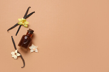 Vanilla extract in bottle with vanilla pods and flowers on beige background. Top view