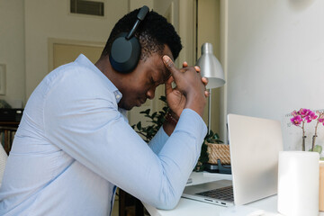 A man typing on the computer at home