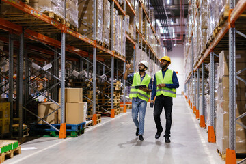Two workers walking at storage center