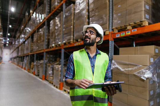 Male indian employee at warehouse distribution center