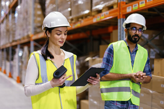 Specialized team strolling warehouse corridor storage room