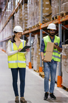 Multicultural quality control workgroup managing goods