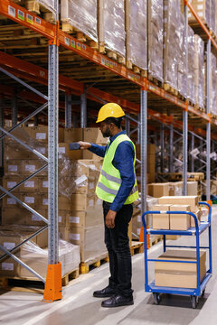 Male worker scanning goods at warehouse