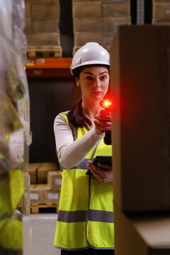 Warehouse worker helmet scaning package distribution center