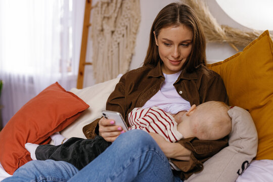 Breastfeed maternal caregiver phone bedroom browse innocence childcare