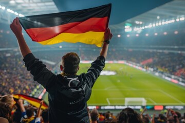 Fototapeta premium Happy German fan at stadium with flag