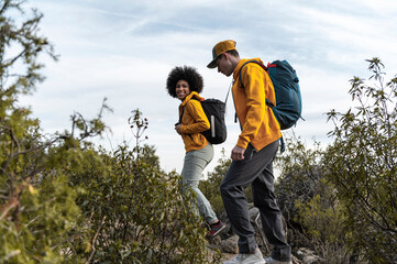 Diverse friends in activewear hiking outdoors
