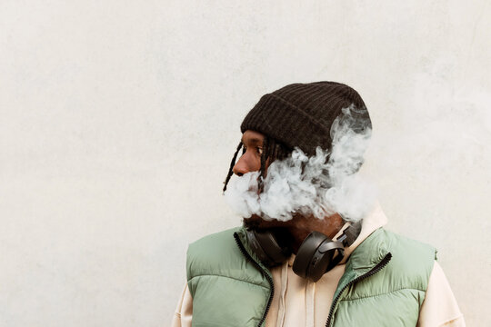 Black man smoking electronic cigarette