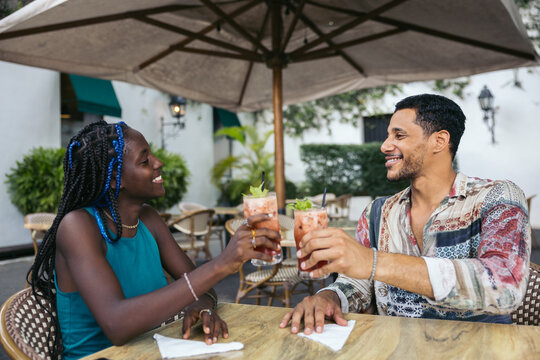 Friends toasting on the terrace of a bar.
