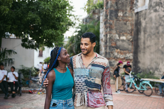 Cheerful friends walking down the street in Santo Domingo
