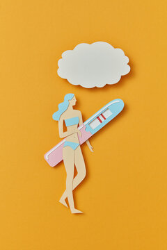 Papercraft woman carrying pregnancy test with two stripes
