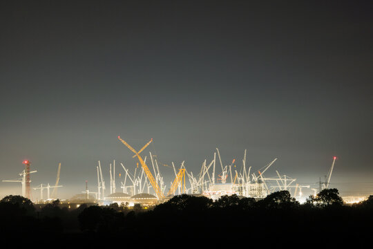 Nuclear power station being built at night. 