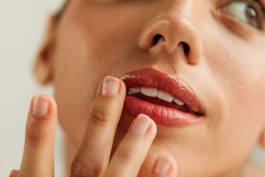 Woman applying lip balm