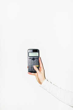Person tapping mathematic/math calculation to calculator with flash