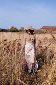 woman in hood standing in field