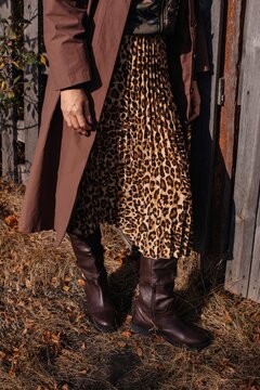 Anonymous woman in stylish outfit with leopard pattern skirt