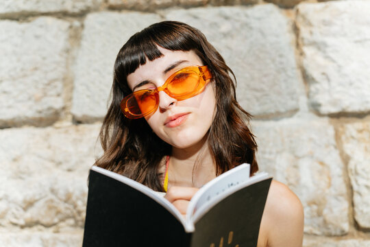 Camera aware woman holding a notebook
