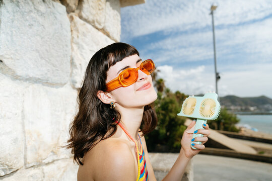 Enjoying a hand crank fan during summer