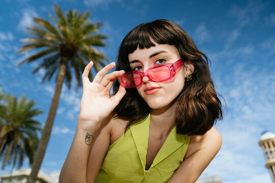 Woman pulling down her sunglasses