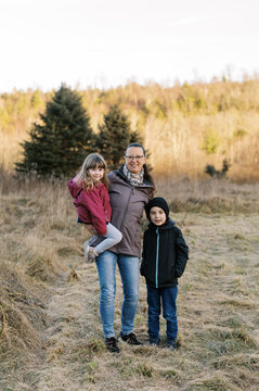 grandmother and grandkids at christmas tree farm