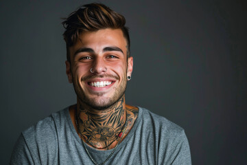 A man with a tattoo on his neck is smiling