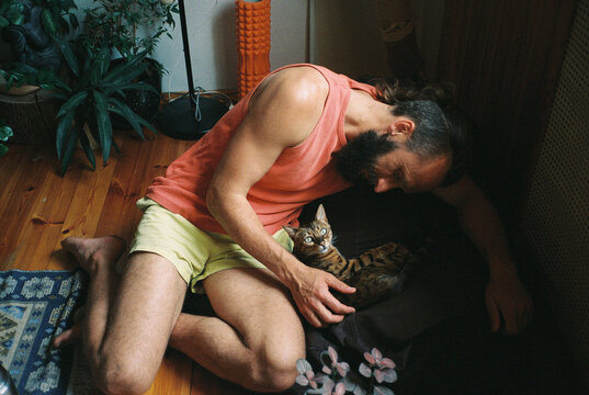 A man looking on his cat