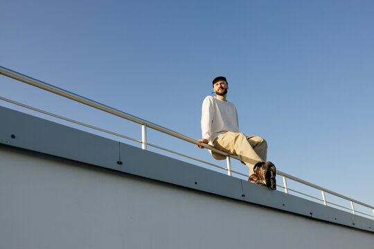A man in roller skates sits outdoors