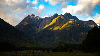 unique stunning landscape of Milford Sound - fjord and tall waterfalls flowing down the wall of a mighty mountain in Fiordland National Park, Southland, New Zealand