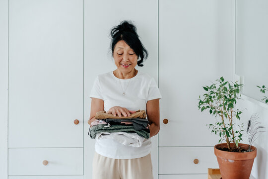 Senior woman standing near closet