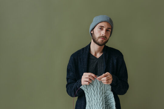 Portrait of knitting modern male.