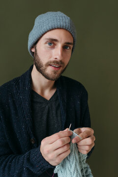 Portrait of knitting modern smiling man.