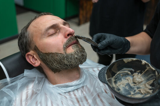  man gets beard dyed at  salon