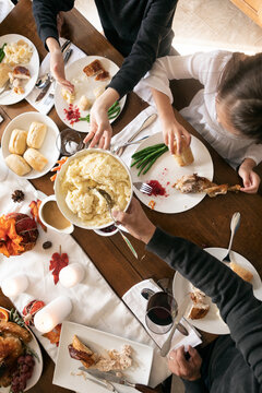 Thanksgiving: Mashed Potatoes Passed Across Table From Overhead