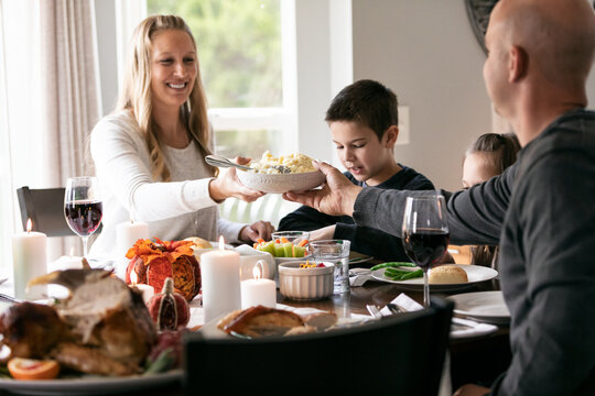 Thanksgiving: Mother Passes Mashed Potatoes Across Table