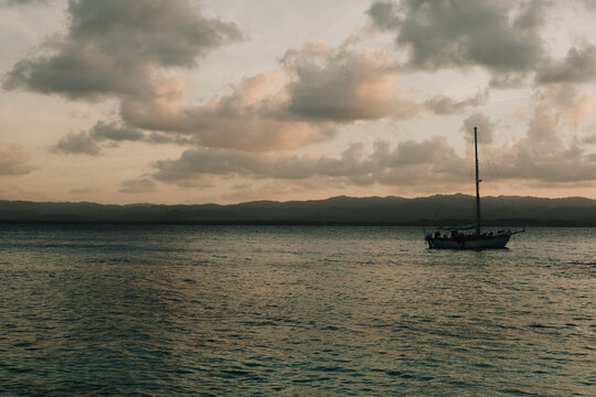 Silhouettes Of boats floating over the sea, a stunning sunset scenery