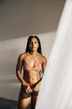 Portrait of a beutiful woman dressed in pale pink underwear.