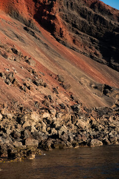 A coastal scene along the ocean, with a row of cliffs