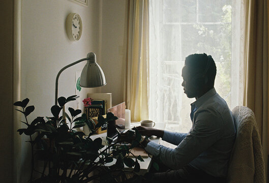A man typing on the computer at home