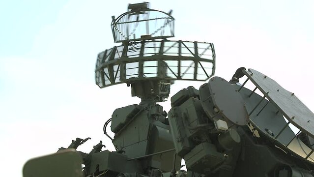 Military air defense radar. Anti missile defense system. Green military radar is rotating - control, surveillance and monitoring of the clear blue air. High tech technology in the army.