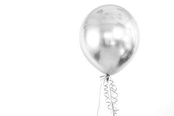 A silver balloon gracefully suspended by a delicate string.