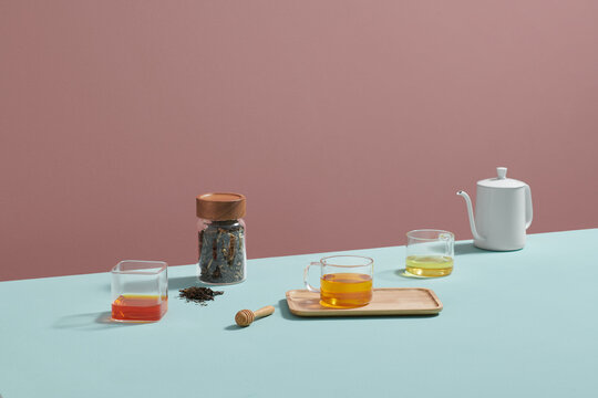 Black tea with tea leaf and honey on color background