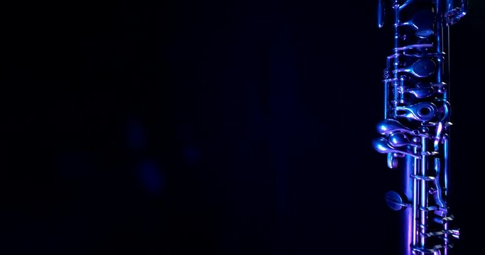 Music instrument falling against dark blue background, oboe