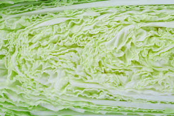 Obraz premium Half of fresh Chinese cabbage as background, top view